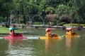 People pedalling boats on a lake in Dusit Zoo, Bangkok, Thailand