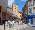 People in the pedestrian center of rochdale with the exchange shopping center on yorkshire street