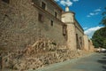 People on pedestrian promenade beside large city wall at Avila