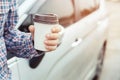 People person business man drinking paper cup coffee of hot in hand while standing car on the side before driving a vehicle