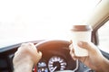 People person drinking paper cup coffee of hot in hand while driving in a car in the morning .transportation and vehicle concept. Royalty Free Stock Photo