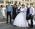 People are photographed on Red Square against the background of St. Basil`s Cathedral. Asian