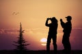 People photographing the sunset with their cell phone