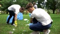 People picking up rubbish in plastic bag, waste treatment problem, recycling