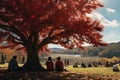 People picnic under the tree at park in autumn season. Generative AI