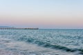 Blue sea and waves. On the pier are fishermen Royalty Free Stock Photo