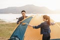 People Pitch a tent on the ground near the lake. Relaxing, traveling, long weeked, holiday concept Royalty Free Stock Photo