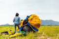 People Pitch a tent on the ground near the lake at sunset. Relaxing, traveling, long weeked, holiday concept Royalty Free Stock Photo