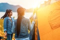 People Pitch a tent on the ground near the lake at sunset. Relaxing, traveling, long weeked, holiday concept Royalty Free Stock Photo