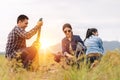 People Pitch a tent on the ground near the lake at sunset. Relaxing, traveling, long weeked, holiday concept Royalty Free Stock Photo