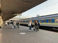 People on the platform of the station are waiting for the train. Men and women meet an approaching train. Concept: tourism, rail