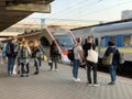 People on the platform of the station are waiting for the train. Men and women meet an approaching train. Concept: tourism, rail