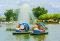 People play animal-shape boat in the amusment park