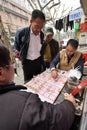 People play Chinese Chess in a street