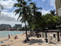 People play in the protected water and hang out on the beach in Waikiki Royalty Free Stock Photo