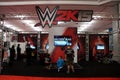 People play video game WWE 2k15 at booth