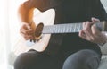 People playing acoustic guitar in the living room Royalty Free Stock Photo