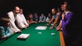 People playing alias game at the party on the pool table