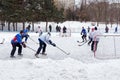 People playing amateur hockey in the city Ice skating rink. Winter playing, fun, snow