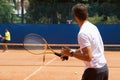 People, playing and competition on tennis court, athlete and action with ball to score. Opponent, intensity and training