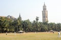 People playing cricket in front of Rajabai Tower at Mumbai