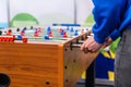 People playing foosball table soccer. Team sport, table football players. Competitive table game Royalty Free Stock Photo