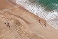 People playing games an empty sandy tropical beach. Nazare Portugal Royalty Free Stock Photo