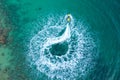 People are playing a jet ski in the sea.Aerial view. Top view. Amazing nature background. The color of the water and beautifully Royalty Free Stock Photo