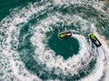 People are playing a jet ski in the sea.Aerial view. Top view.amazing nature background.The color of the water and beautifully br Royalty Free Stock Photo