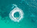 People are playing a jet ski in the sea.Aerial view. Top view.amazing nature background.The color of the water and beautifully br Royalty Free Stock Photo