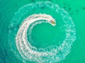 People are playing a jet ski in the sea.Aerial view. Top view.amazing nature background.The color of the water and beautifully br Royalty Free Stock Photo