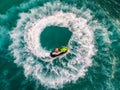 People are playing a jet ski in the sea.Aerial view. Top view.amazing nature background.The color of the water and beautifully br Royalty Free Stock Photo