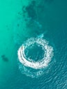 People are playing a jet ski in the sea.Aerial view. Top view.amazing nature background.The color of the water and beautifully br Royalty Free Stock Photo