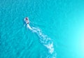 People are playing a jet ski in the sea.Aerial view. Top view.amazing nature background.The color of the water and beautifully br Royalty Free Stock Photo