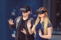 People playing new virtual games on metaverse blockchain technology with vr goggles