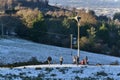 People playing outdoor snow games and doing activities beside wind turbine at Dublin Panoramic View Point, Killakee, Co. Dublin