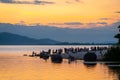 People playing on the shore under dramatic panorama evening sky