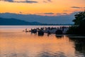 People playing on the shore under dramatic panorama evening sky