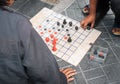 People playing Thai chess on the floor Royalty Free Stock Photo