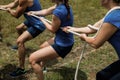 People playing tug of war during obstacle training course Royalty Free Stock Photo