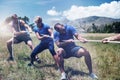 People playing tug of war during obstacle training course Royalty Free Stock Photo