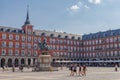 People at The Plaza Mayor Town square and the bronze statue of King Philip III. Madrid, Spain. Royalty Free Stock Photo