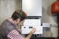 Plumber repairing a condensing boiler Royalty Free Stock Photo