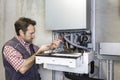 Plumber repairing a condensing boiler Royalty Free Stock Photo