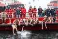 People plunge to retrieve a wooden cross thrown into the sea, du