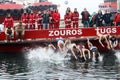 People plunge to retrieve a wooden cross thrown into the sea, du