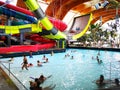 People in the pool with thermal water and giant slide Royalty Free Stock Photo