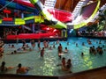 People in the pool with thermal water and giant slide Royalty Free Stock Photo