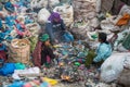 People from poorer areas working in sorting of plastic on the dump. Royalty Free Stock Photo
