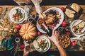 People pouring champagne and celebrating Thanksgiving day at home, top view